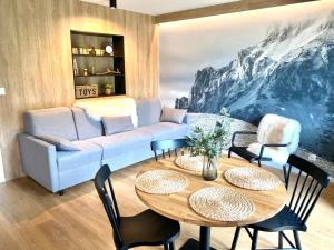 a living room with a couch and a table at Apartmán Bôry Terchová in Terchová