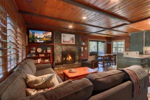 a living room with a couch and a fireplace at 45 The Overlook in Wawona