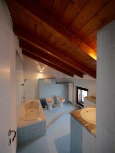 a large bathroom with two toilets and a tub at B&B Como Lake Cottage in Lecco