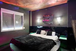 a bedroom with a bed with a painting on the wall at Contemporary Villa in Atarfe with Private Pool and Mountain View in Atarfe