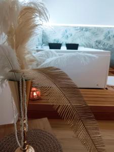 a bedroom with a bed and a table with a plant at Casa Petrí Home SPA in Palermo