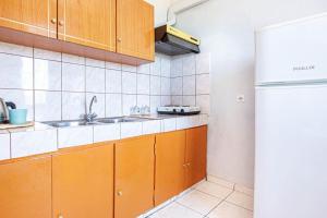a kitchen with a sink and a refrigerator at Blue Maraçi 1 Beach Access nd Parking in Himare +19 photos