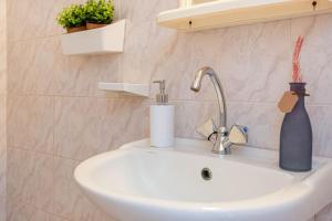 a bathroom sink with a blue vase sitting on it at Blue Maraçi 1 Beach Access nd Parking in Himare