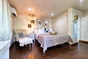 a bedroom with a large bed and a chair at Jasmine Garden Bungalow in Lamai