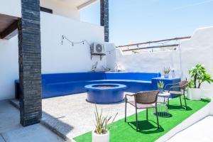 a patio with a table and chairs and a fountain at Casa Arrecife - Dorado Suite, Fast Wifi & Balcony! Beach is steps away! in La Ventana