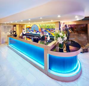 a lobby with a blue counter in a building at Güneş Hotel Merter in Istanbul