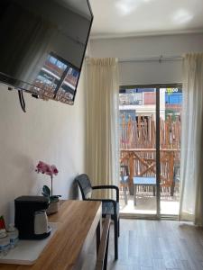 a living room with a table and a view of a deck at Hotel Pelecanus Suites Holbox in Holbox Island