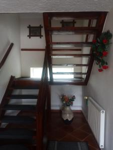 a staircase in a house with a vase of flowers at Lorsby- wędkarska oaza in Mrągowo