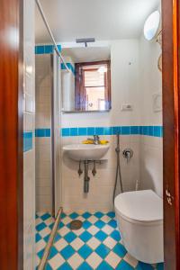 a bathroom with a toilet and a sink at Dependance Rosetta in Minori +21 photos