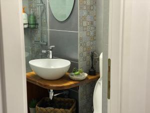 a bathroom with a white sink and a mirror at M & A Accommodation in Topliţa