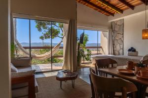a living room with a view of the ocean at Lofts Lobo Guará in Alto Paraíso de Goiás