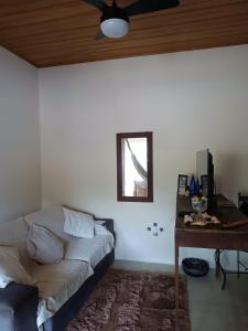 a bedroom with a bed and a ceiling fan at ALOHA#Sossego in Ubatuba