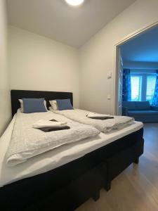 a bedroom with a large bed with white sheets at First Aparthotel Olive in Rovaniemi