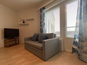 a living room with a couch and a television at First Aparthotel Olive in Rovaniemi