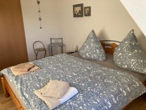 a bed with two pillows and towels on it at Seenplatte in Malchow