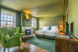 a bedroom with a bed and a fireplace at Villa Cascais Boutique Hotel in Cascais