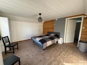 a bedroom with a bed and a table and a chair at Cosy House in Swedish Lapland in Överkalix