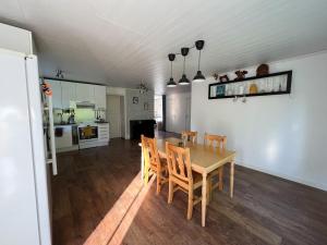 a kitchen and dining room with a table and chairs at Cosy House in Swedish Lapland in Överkalix