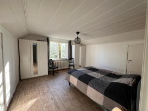 a bedroom with a bed and a window in it at Cosy House in Swedish Lapland in Överkalix +7 photos
