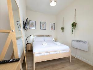 a small bedroom with a bed and a staircase at Guest Rooms In Anfiled Near Stadium, Free Parking in Liverpool