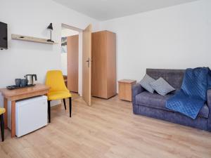 a living room with a couch and a table at Caro - Blisko Morza Łeba in Łeba