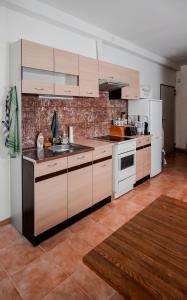 a kitchen with white appliances and a brick wall at Edi Birtok in Oroszló +28 photos