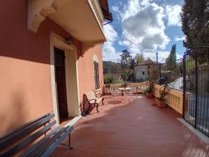 a balcony of a house with benches and a table at Ca' da Carmela in Savignone