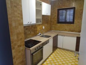 a small kitchen with a sink and a stove at Andjela&Sara in Trebinje