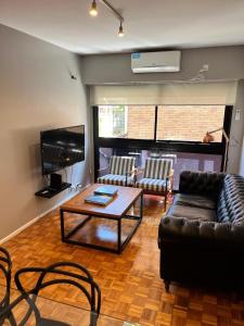 a living room with a couch and a coffee table at Castex Palermo Chico in Buenos Aires