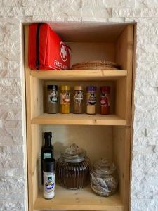 a wooden cabinet filled with food and spices at Maisonette Edna in Mechernich +8 photos