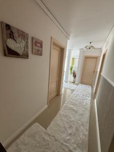 an empty hallway with a white rug on the floor at SIBIU Bach Penthouse in Sibiu