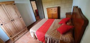 a bedroom with a bed with red pillows on it at Club JM Lanzarote in Tabayesco