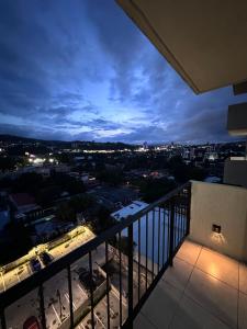 a view of a city at night from a balcony at View 15, San Francisco Tower in San Salvador