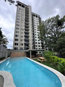 a swimming pool in front of a tall building at View 15, San Francisco Tower in San Salvador