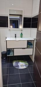 a small bathroom with a sink and a mirror at Luxus Apartments in Kelibia +37 photos