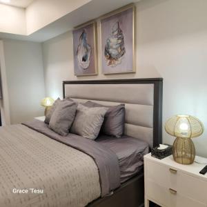 a bedroom with a bed with two pictures on the wall at Cozy Cove Retreat Escape to Tranquility Stay in Simplicity in Dead Man's Flats