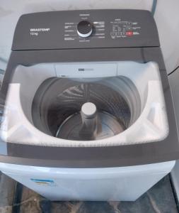 a washing machine sitting on top of a machine at Hospedagem Rancho Fundo in Diamantina