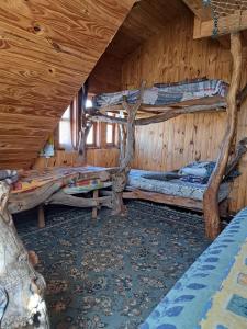 a room with three bunk beds in a cabin at el refugio de caniche in Caviahue +11 photos
