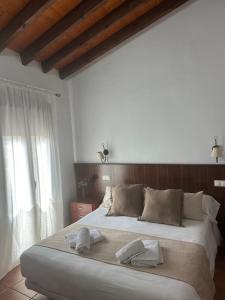 Postel nebo postele na pokoji v ubytování Hostal Camarina