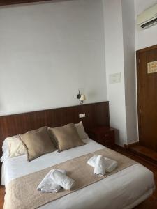 Postel nebo postele na pokoji v ubytování Hostal Camarina