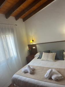 Postel nebo postele na pokoji v ubytování Hostal Camarina