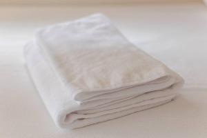 a stack of white towels sitting on a table at wood and blue 江ノ島 in Katase +39 photos