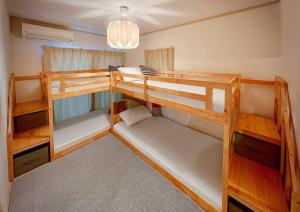 a room with two bunk beds and a chandelier at wood and blue 江ノ島 in Katase