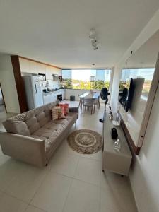a large living room with a couch and a table at Barra beach in Barra de São Miguel +3 photos