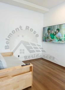 バギオにあるBelmont Rose Residencesの壁に絵が飾られたベッドのある寝室