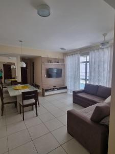 a living room with a couch and a table at Apto perfeito em Arraial do Cabo - Prainha in Arraial do Cabo