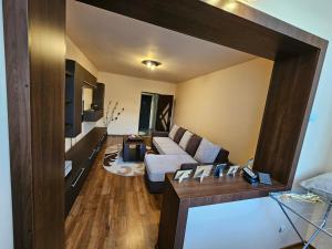a living room with a couch and a table at Perfect home Ground floor in Petroşani