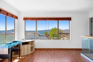 a kitchen with large windows and a view of the city at Lakeview Oasis in Rotorua