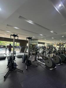 a gym with a lot of treadmills and machines at Mi Casa - Cozy Studio with FREE access to Fitness Centre, swimming pool and stunning City View located near the CBD of Ortigas, Makati, BGC in Manila