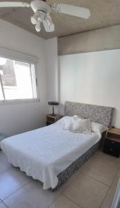 a bedroom with a bed and a window and a ceiling at Nice San Telmo in Buenos Aires